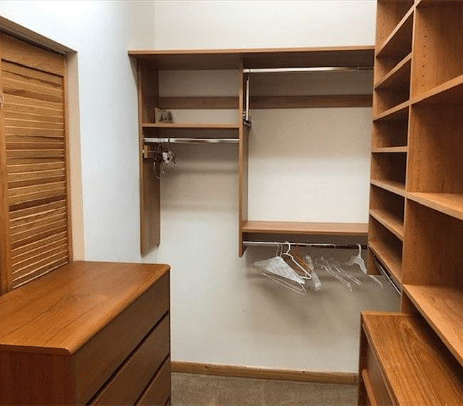 Two dressers inside closet.