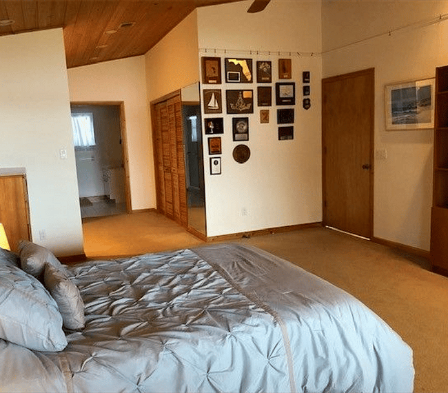 Primary bedroom with dressing area outside of walk-in closet.