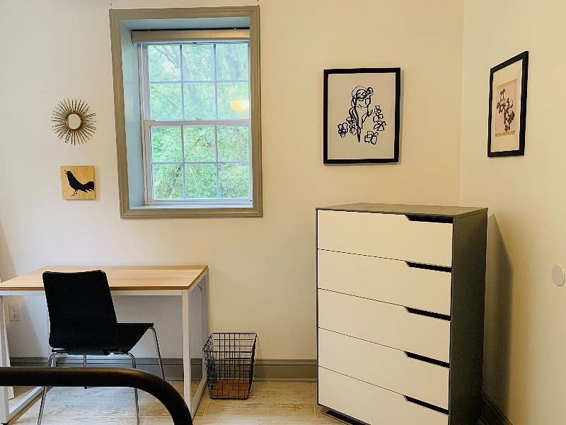 Natural lighting streams through the bedroom over the work station
