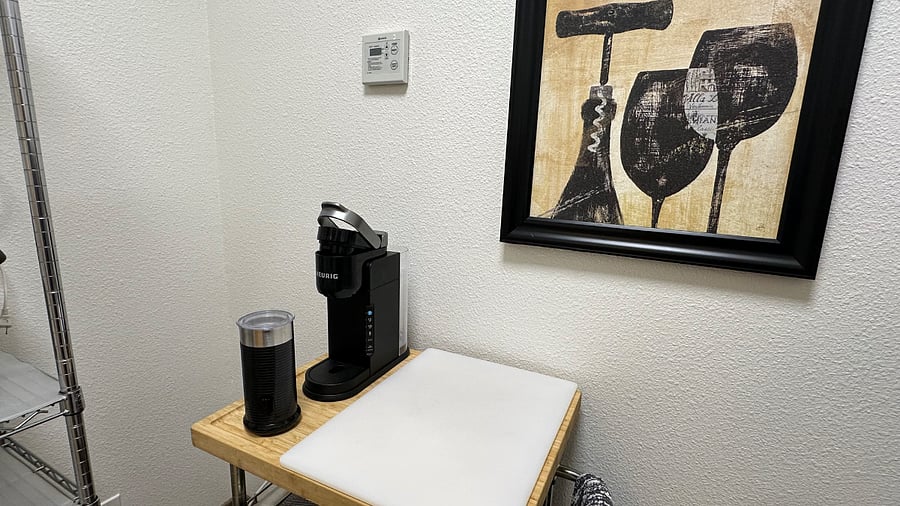 Keurig Coffee dispenser and frother next to cutting board