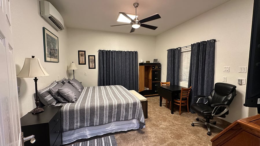 New decor as of July 2025 for king bed, window coverings and black out drapes, and wardrobe closet. Optional clothing space in rolling chrome wardrobe/shelving across from kitchen appliances.