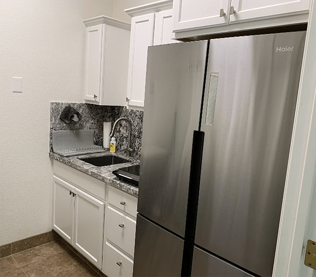 Kitchenette with full size cabinent depth refrigerator/freezer, single induction countertop 