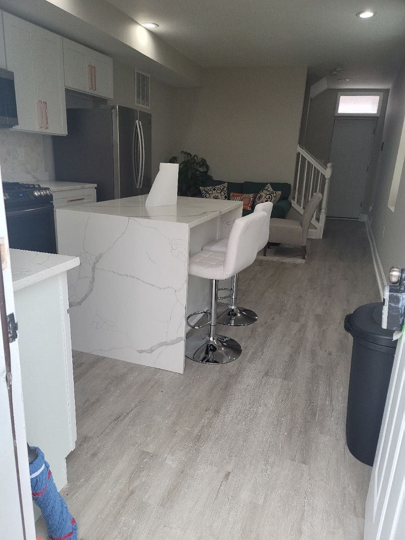 Quartz island with white waterfall finish in kitchen