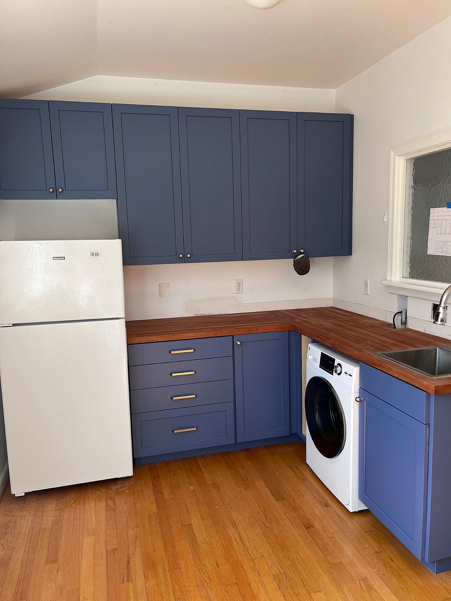 Kitchen with full sized fridge, washer dryer combo, 2 hot plates, convection oven, microwave, plenty of storage.