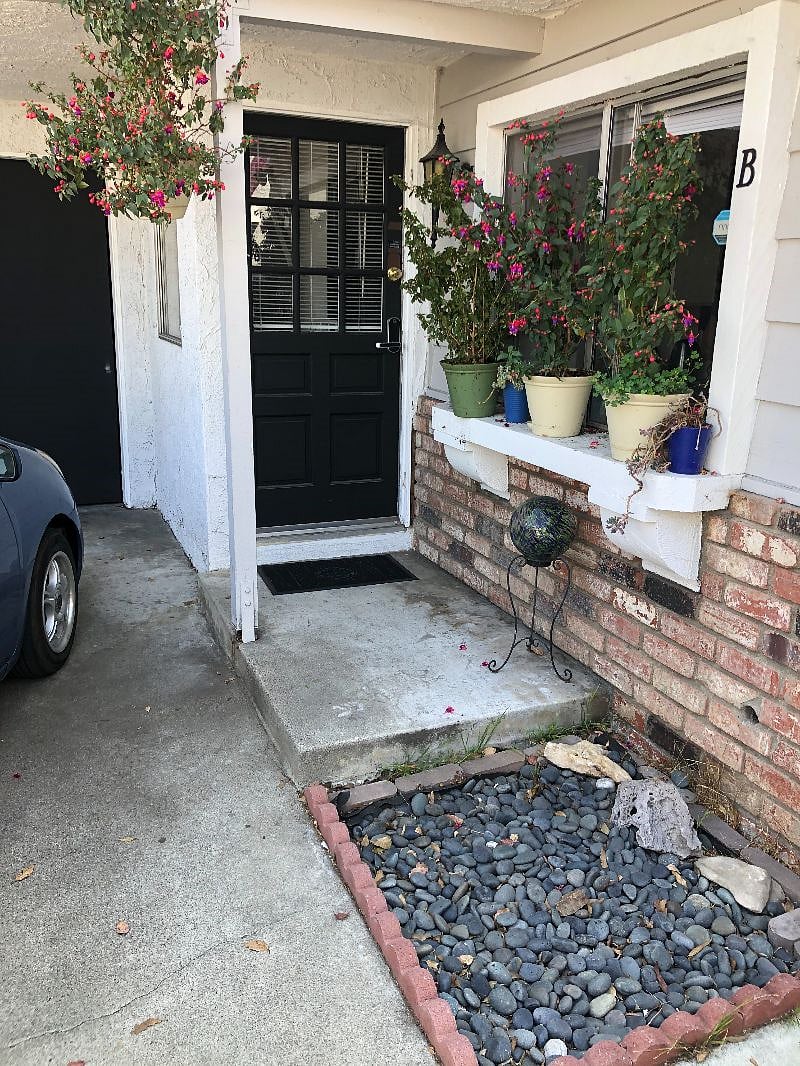 Entrance at the end of the driveway all the way on the left. 
