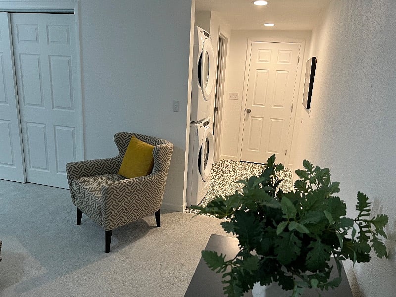 Just around the corner is your stacked washer and dryer and entrance to the spacious bathroom.