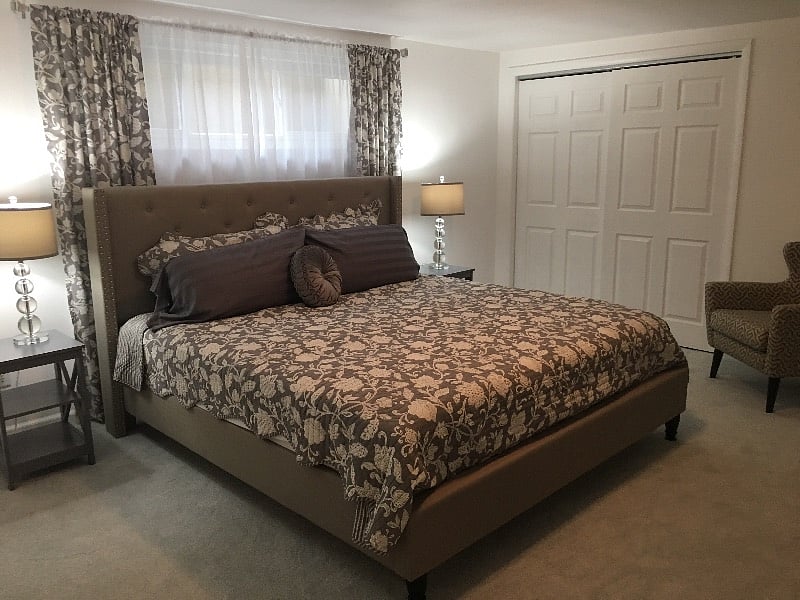 This is one big bedroom! King sized bed, night stands and gorgeous lamps plus an armchair and a vanity with large mirror. Double closet with built-in storage for towels and linens. Black out shade in the window for day sleepers.