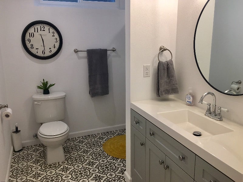 This is the very large bathroom with a single sink vanity that has lots of storage. Just around the wall is a the walk-in shower. And I love the vinyl floor.