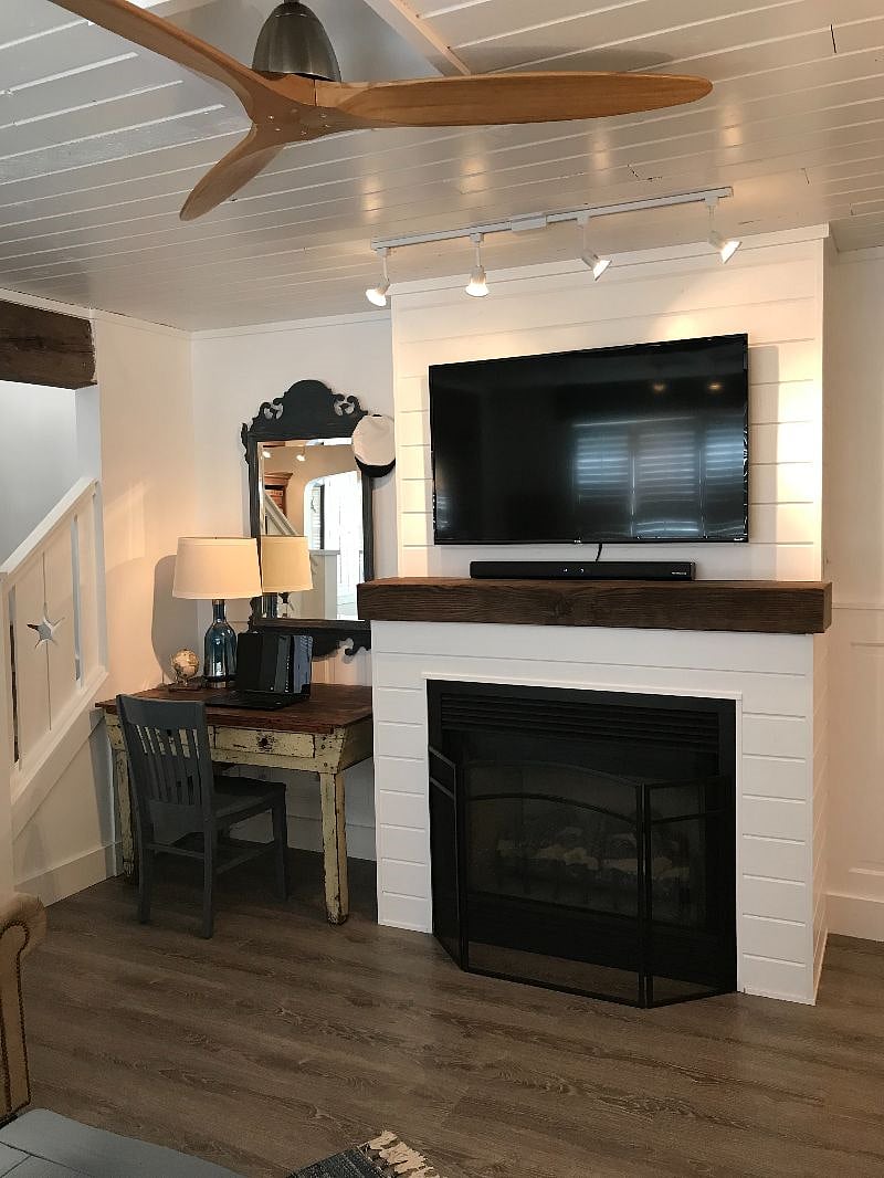 Living room with desk, gas fireplace and 52-inch smart TV. Includes cable (Comcast), Netflix, Amazon Prime, Hulu, Discovery+ and Acorn.