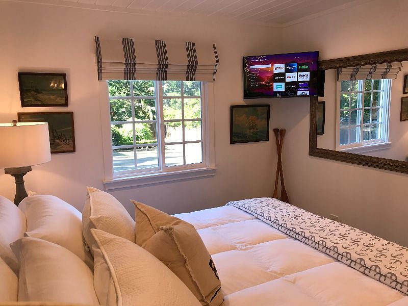 Bedroom with 32-inch smart TV. Includes: Cable (Comcast), Netflix, Amazon Prime, Hulu, Discovery+ and Acorn.