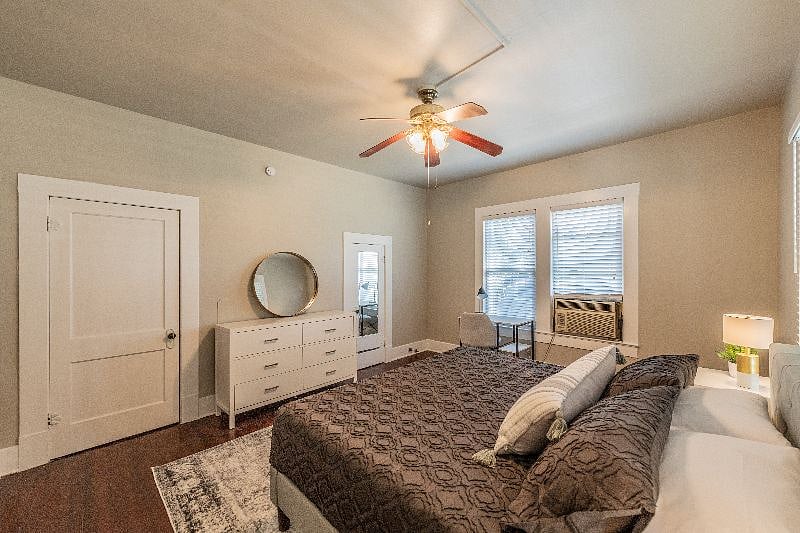 Bedroom view of King memory foam mattress, bureau and air conditioning unit