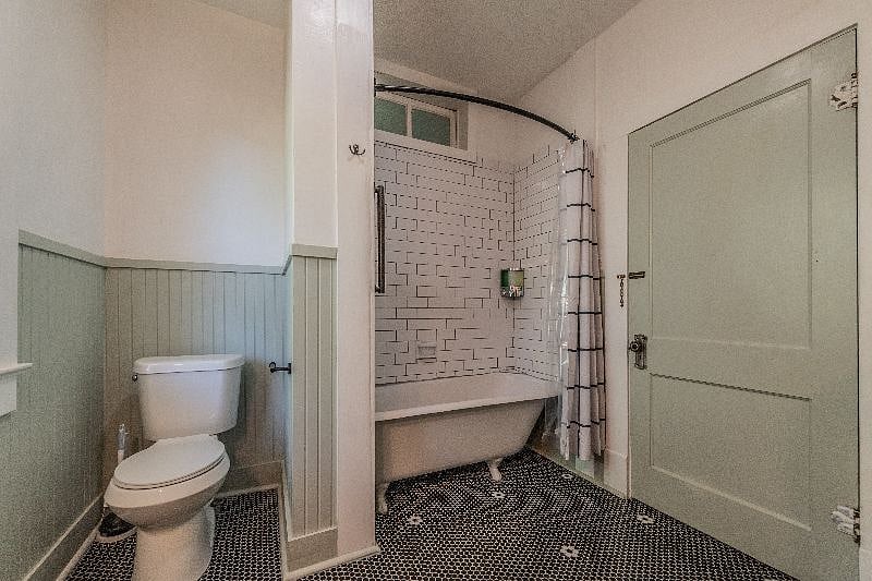 Hallway bathroom with original cast iron clawfoot tub