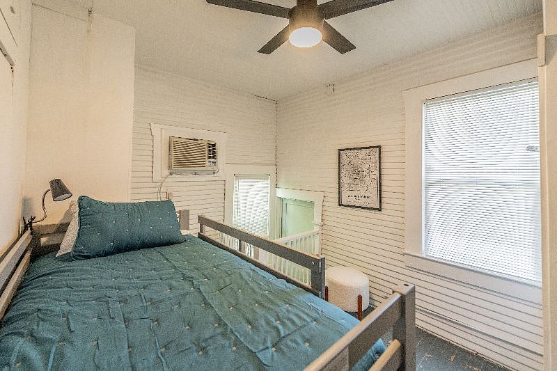 Bunkroom view from top bunk, stairwell to side yard with safety gate at top of stairs, door is locked with deadbolt