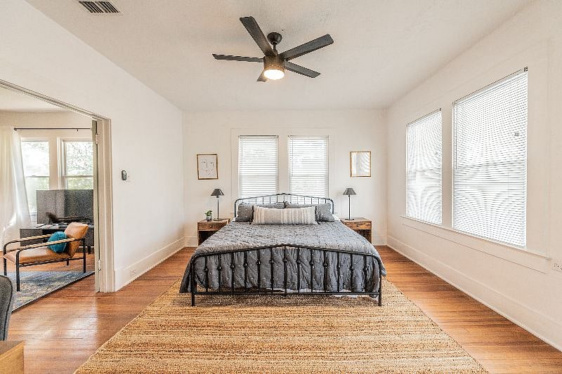 King bed with green tea infused memory foam mattress, french doors lead to living room