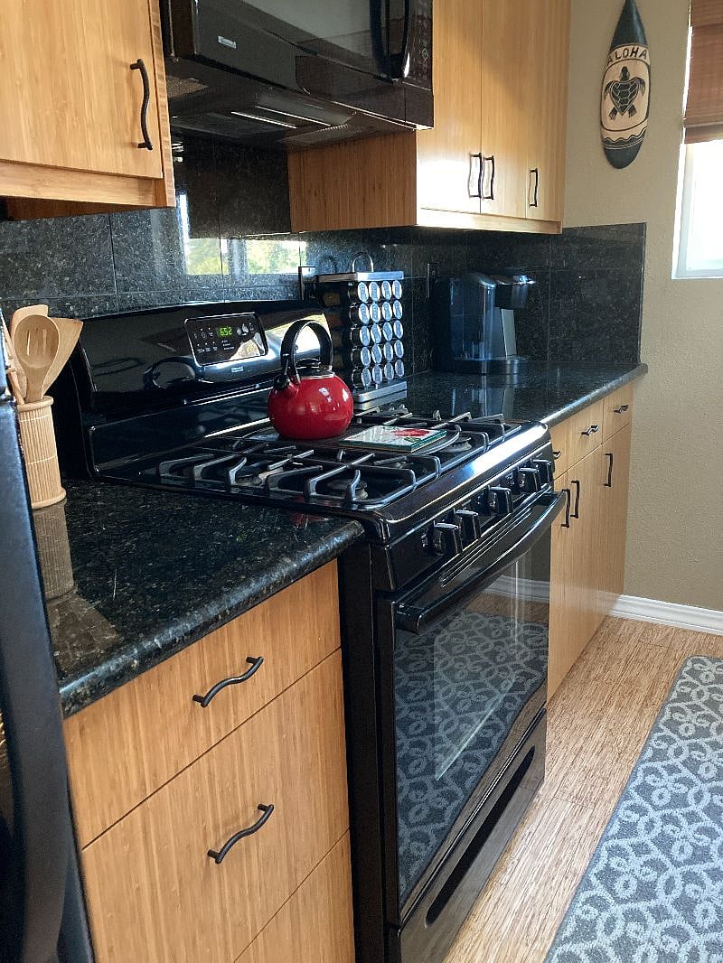 Spacious kitchen has full-size gas range/oven and refrigerator. 