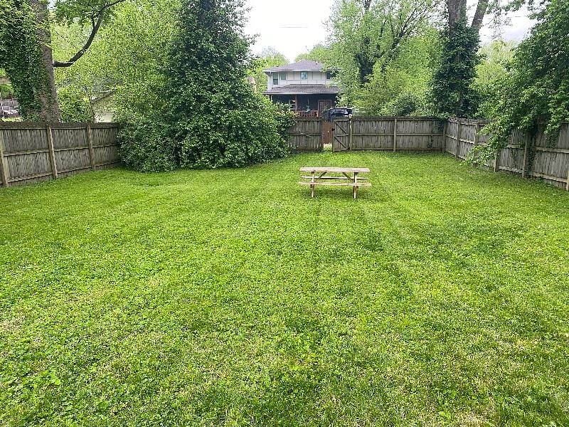 Very large fenced-in backyard with bench for eating outside or relaxing in nice weather!