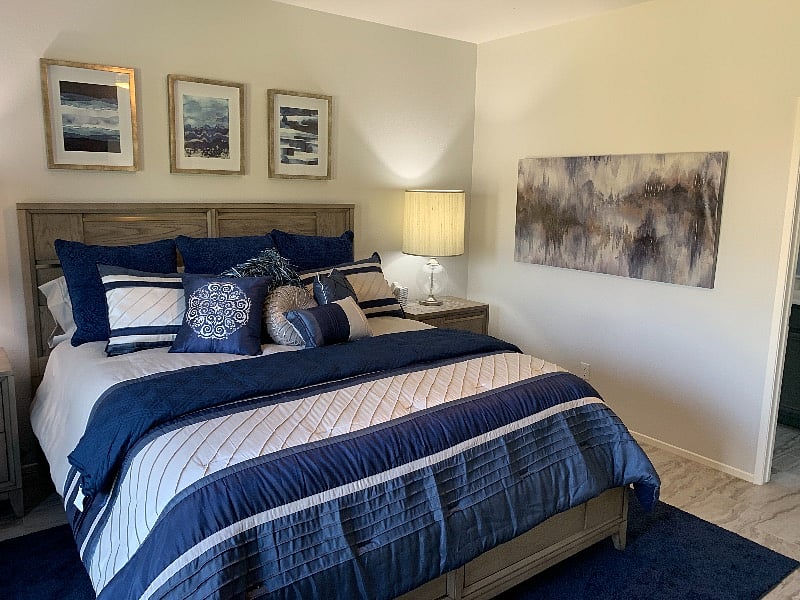 The primary bedroom features a California King size bed, luxury bedding and a high quality mattress.