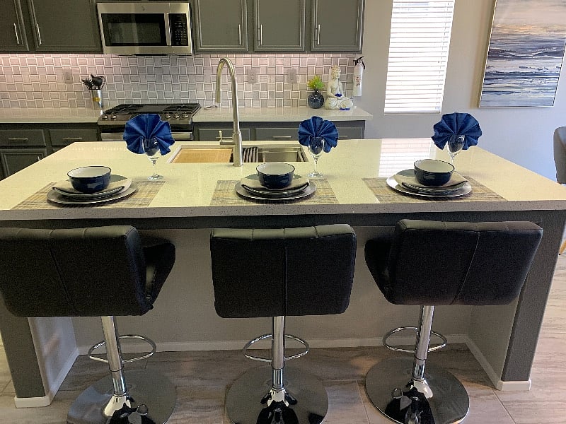 The kitchen counters and island feature sparkling Quartz finishes. The backsplash is gorgeous marble!