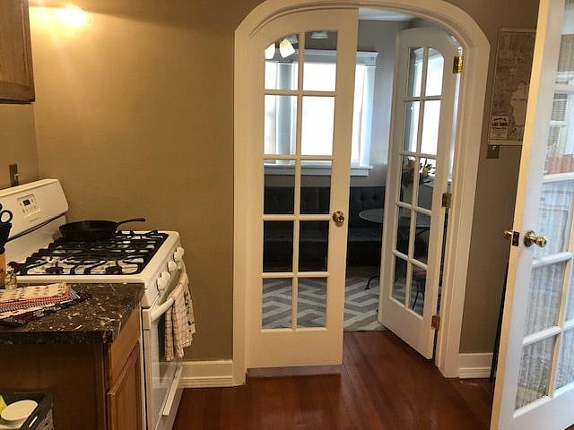 Den, off the kitchen.  Inside this, there are stairs that lead up to the master, on the left. There is also a second set of french doors here, too, for more privacy :)