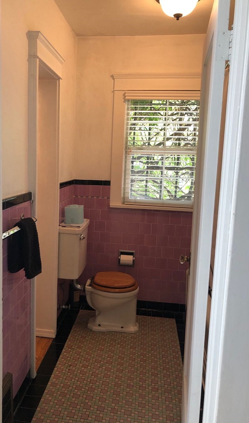 Full bathroom (shower-tub is on the right.) Authentic vintage everything. Dressing room for lower bedroom and sink are through the doorway on the left.
