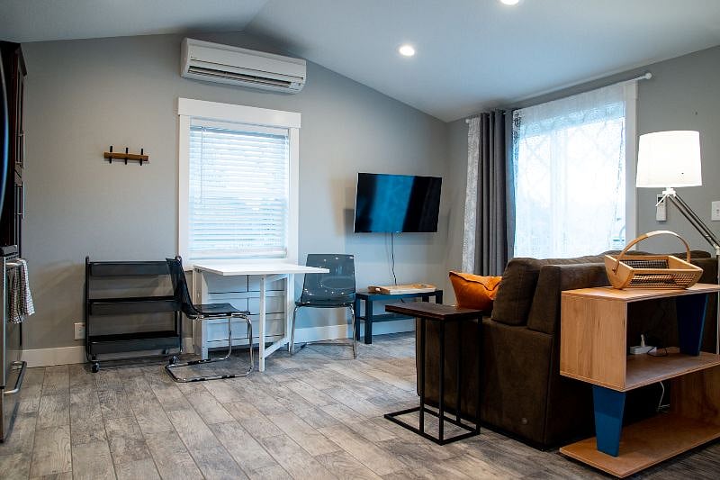 Living and dining area. Sofa converts to Queen Size bed. Dining table doubles as a desk.