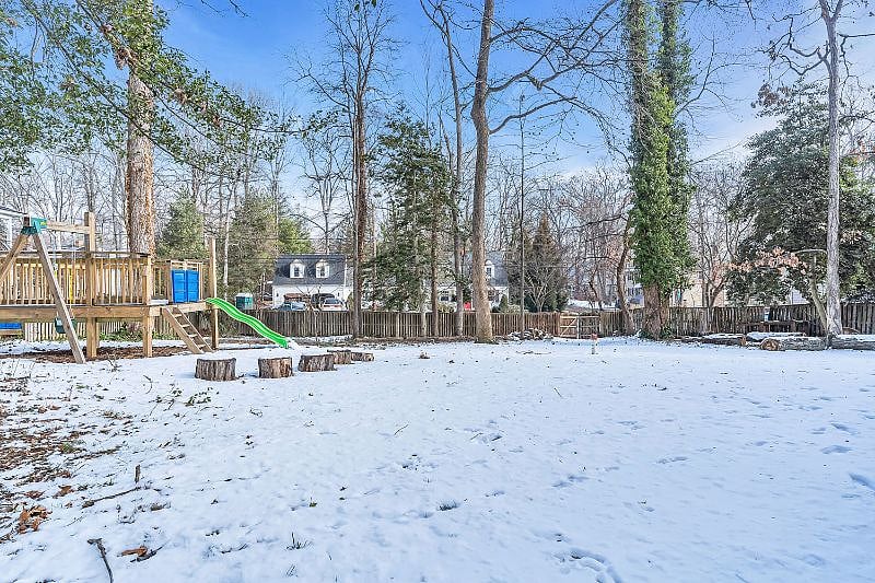 Play area and fully fenced backyard with patio