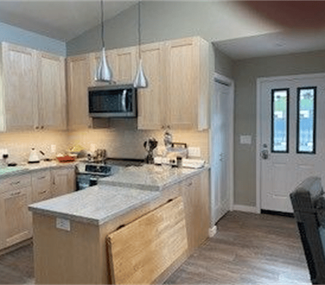 Kitchen facing door to outside. Laundry room on left of front door. Entry closet on right of front door.