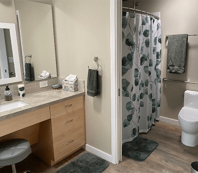 Bathroom facing toward shower & toilet with pocket door.
