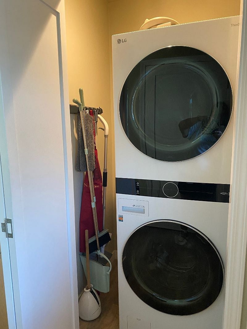 Quiet washer/dryer in closet with cleaning tools.