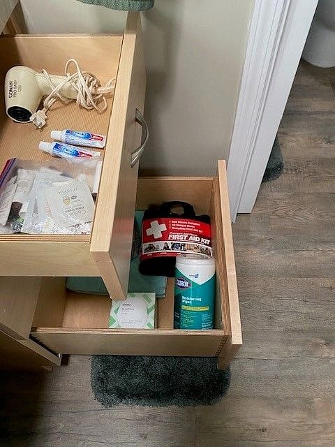 Bathroom supplies including first aid kit.