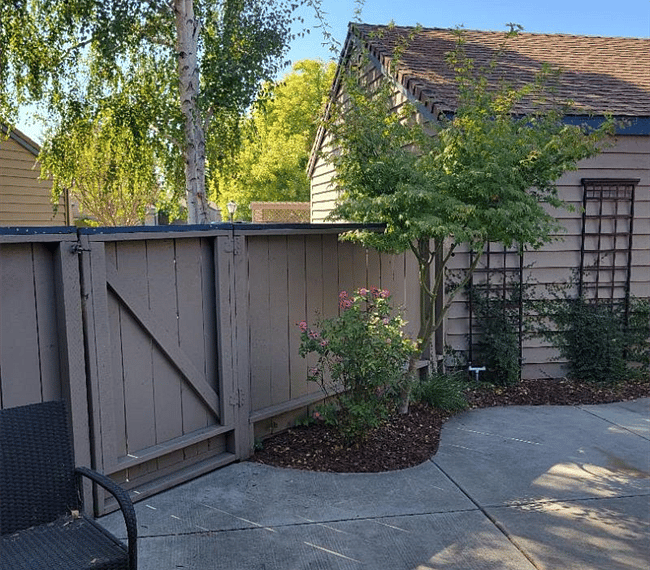 fenced in backyard with gate access to enter kitchen