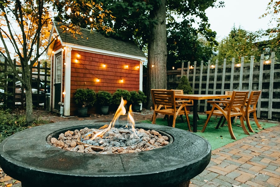 Peaceful courtyard with outdoor dining and lounging areas, plus a lockable shed for bicycle storage