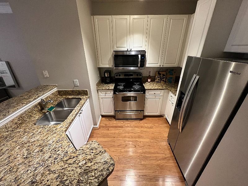 Fully stocked kitchen with stainless steel appliances: Microwave, Fridge/Freezer, Stove, Oven, Dishwasher, Sink, Keurig Coffee Maker and dishware, silverware and cookware.
