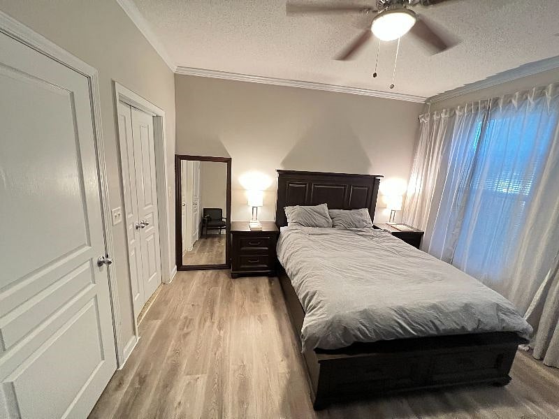 Spacious main bedroom with expensive designer furnishings offering light-blocking curtains, fan, noise machine, ambient lighting, walk-in closet and full height mirror and TV.