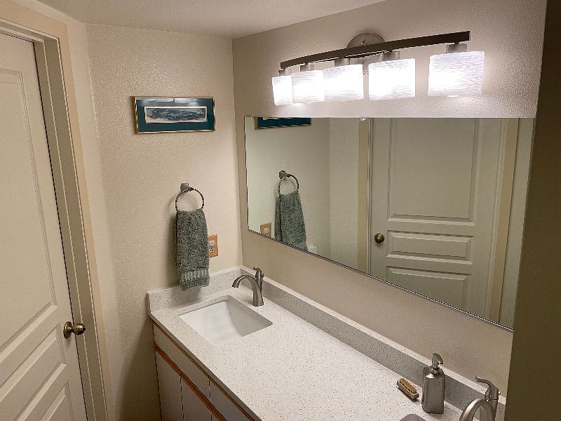 Quartz countertop with two undermount sinks.