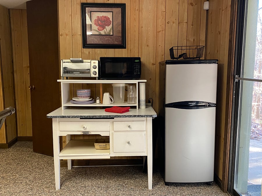 Kitchenette with mini fridge, microwave, toasterover/ air fryer and coffee pot