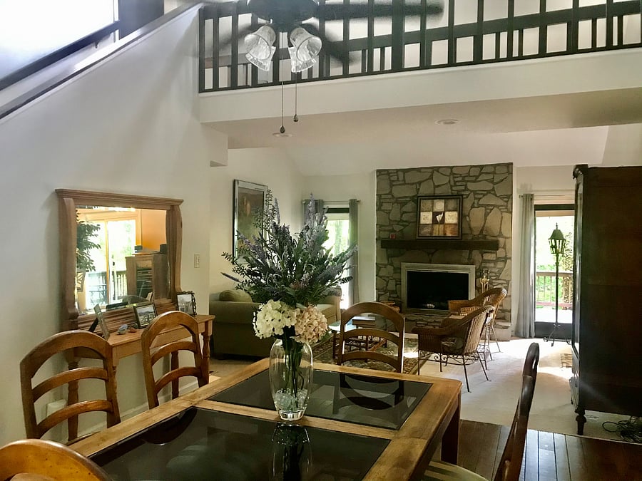 Open living room / dining room area with cathedral ceilings and catwalk
