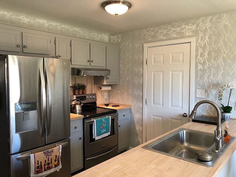 Fully stocked kitchen with dishes, cookware, coffee maker, filtered water, ice maker, toaster and microwave.