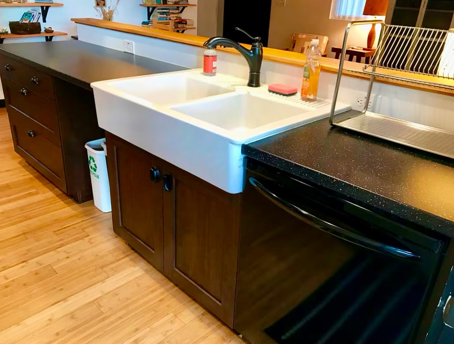 Large ceramic farmhouse sink, dishwasher, dish drying rack, and lots of large drawers for storage