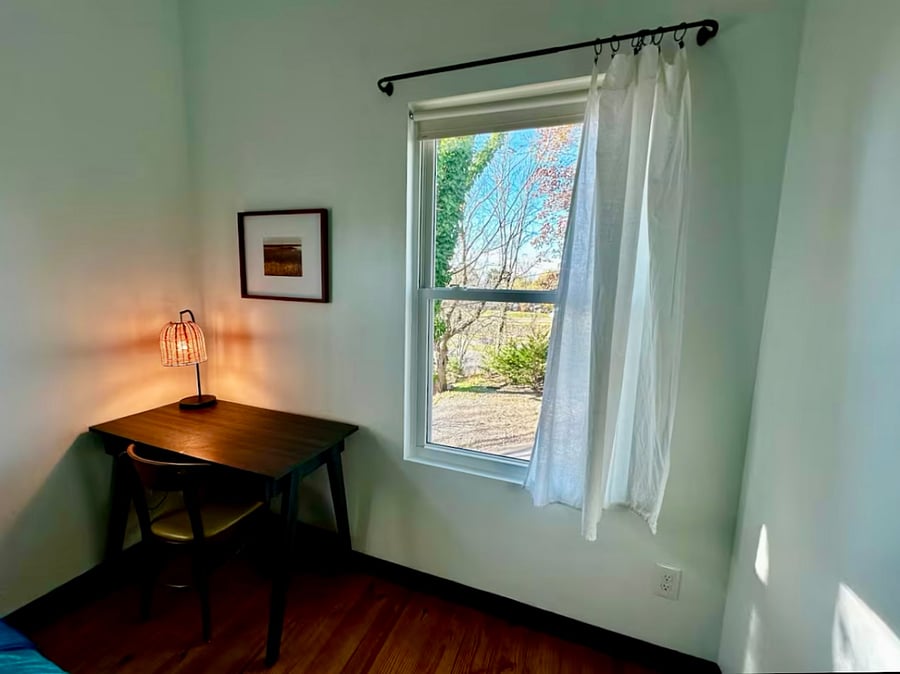 Desk with comfortable chair, lamp, and outlet for computer provides the perfect workspace