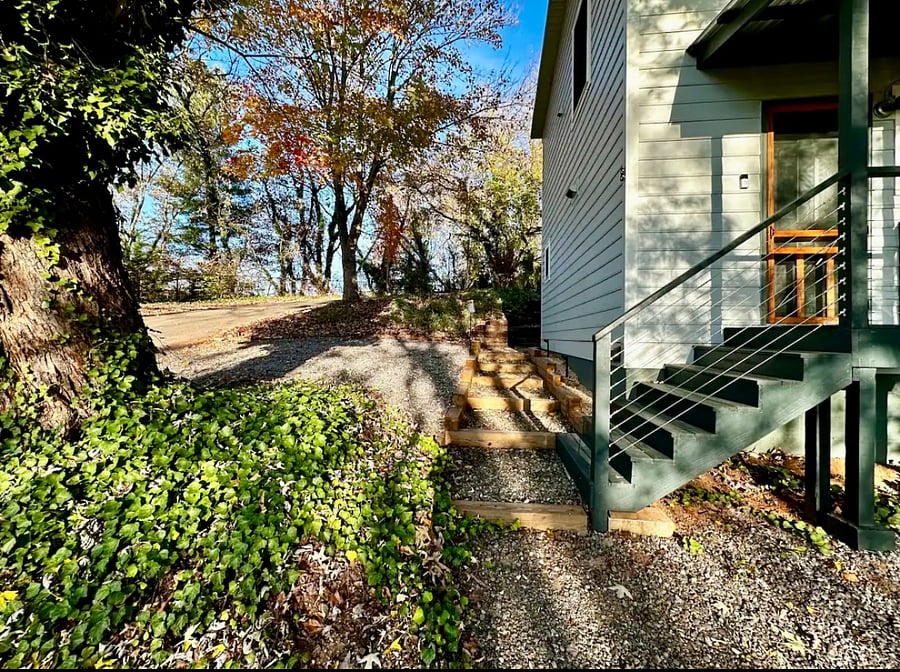Driveway plus gravel parking pad adjacent to house provides parking for 3 cars