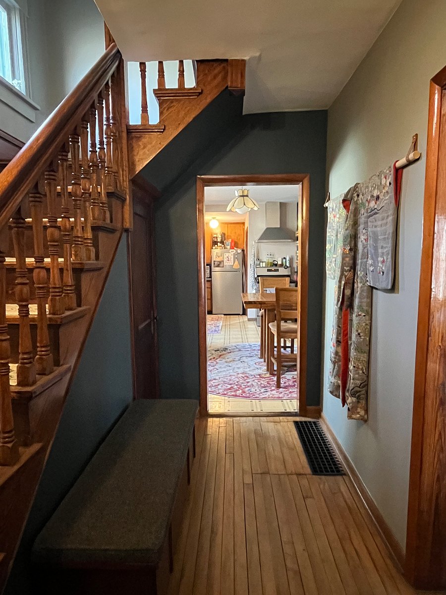 Another view in the same direction. Door to the basement (laundry location) is visible under the stairs.