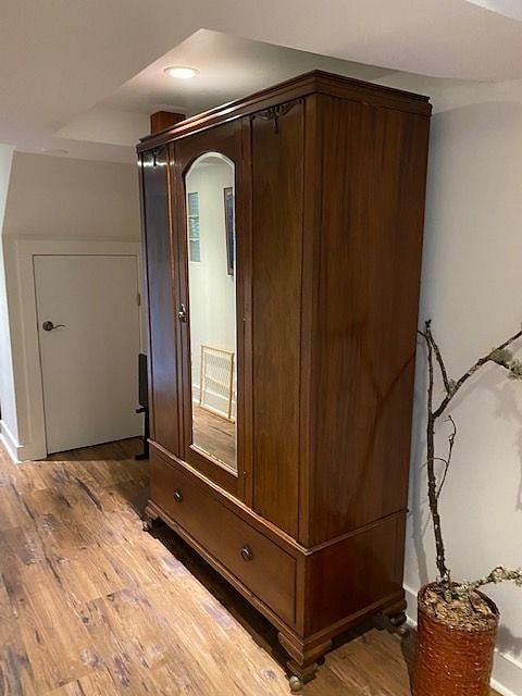Coat and boot storage in armoire.