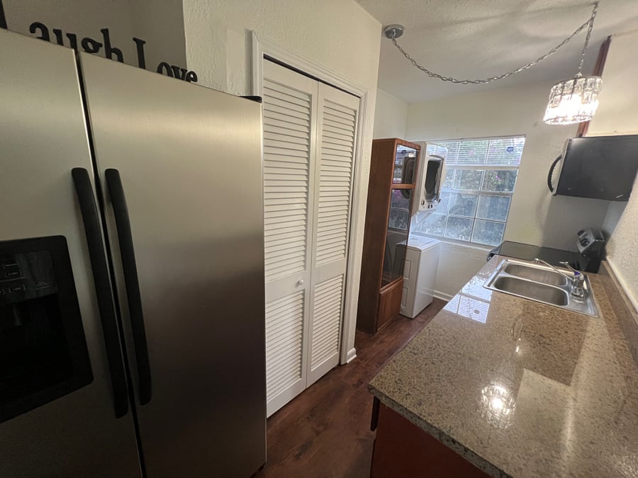 Kitchen with a stackable washer and dryer.