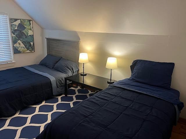 Upstairs bedroom with a full and a twin bed.