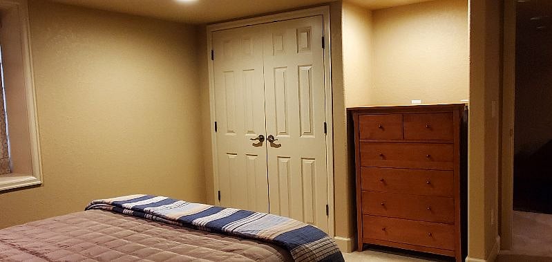 The bedroom closet is finished with french doors which provides easy access to the full shelf and hanging areas of the closet.