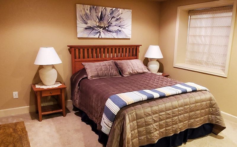 The guest bedroom is furnished with a queen bed, two nightstands and two dressers.