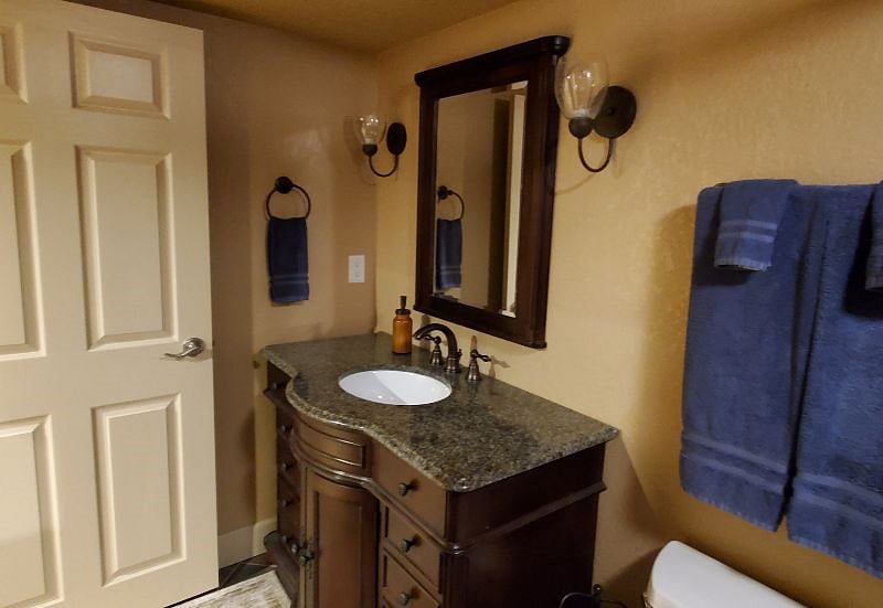 Basement quarters include a private bathroom for the guests' use.