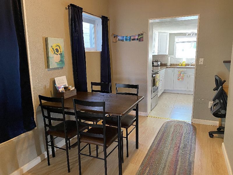 Lots of natural light in the dining room -looking towards the kitchen and a small desk in the corner nook