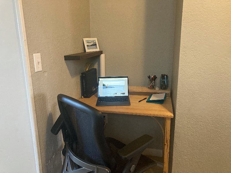 Desk in this corner nook with an adjustable rolling desk chair